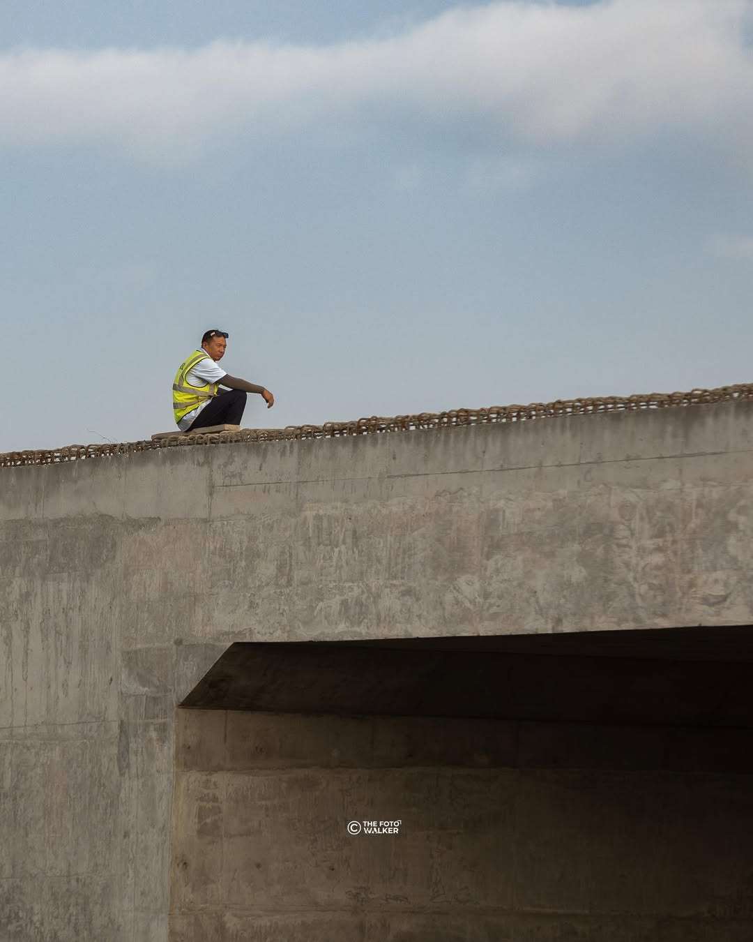 A worker overlooking a busy road in Accra
