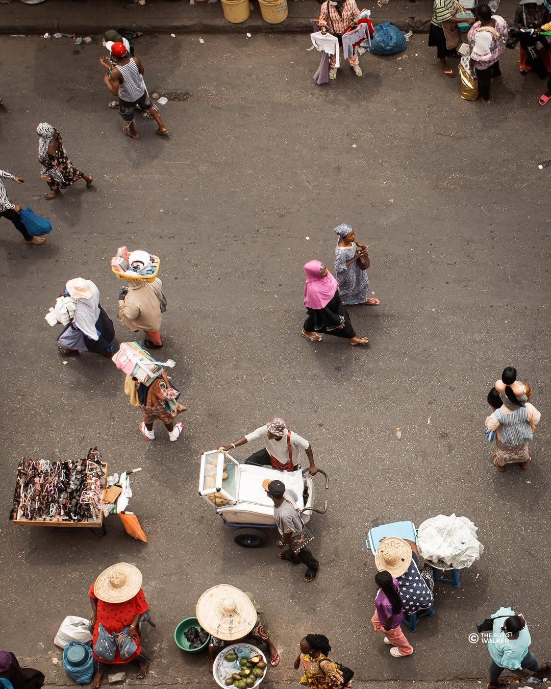 A busy Accra market street with trotros and crowds on the move