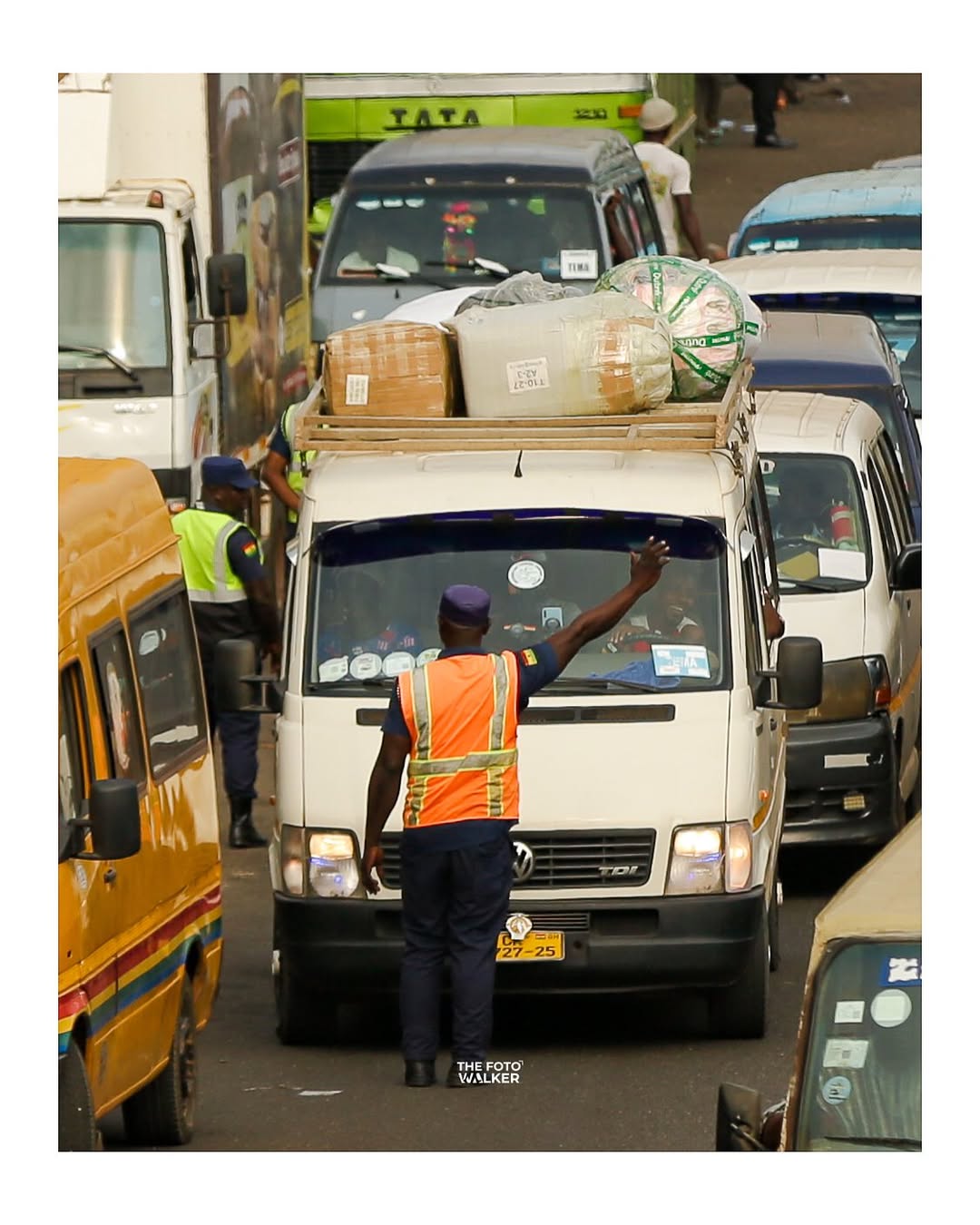 A trotro pulling up at the roadside on an Accra street
